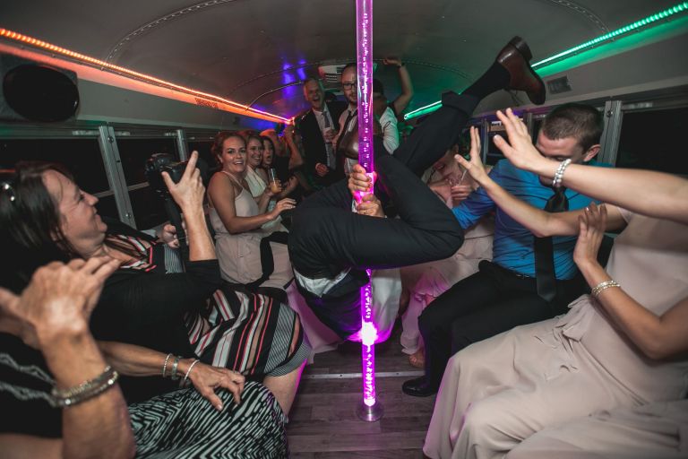 Guest dancing on pole on party bus