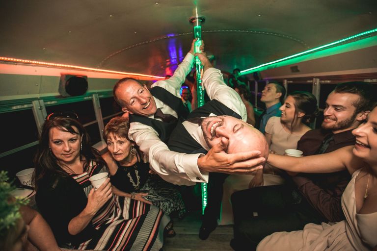 Men dancing on wedding party bus