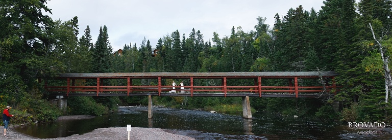 Panorama of two brides on bridge at lake superior