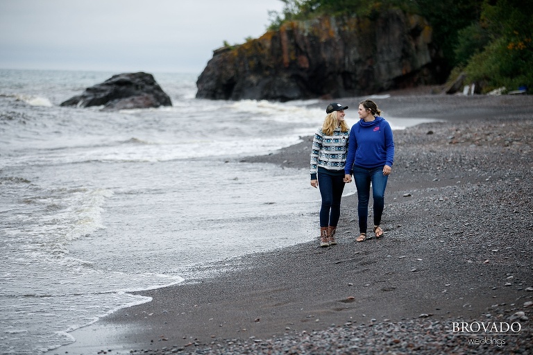 holding hands during a pre-wedding hike along the north shore