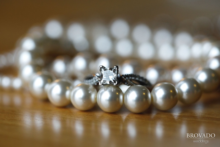 Closeup of wedding ring and pearls