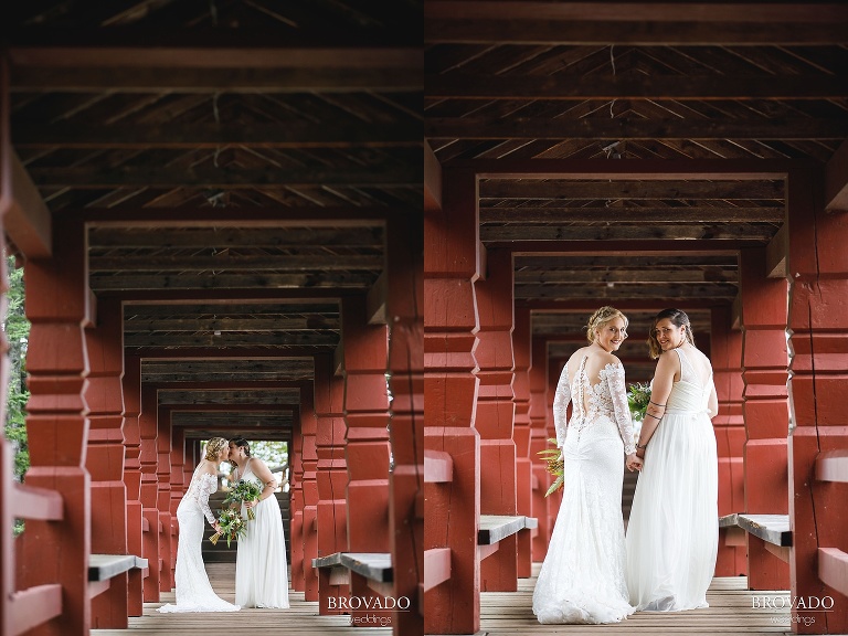 Two brides kissing on Lake Superior bridge at Lutsen Resort