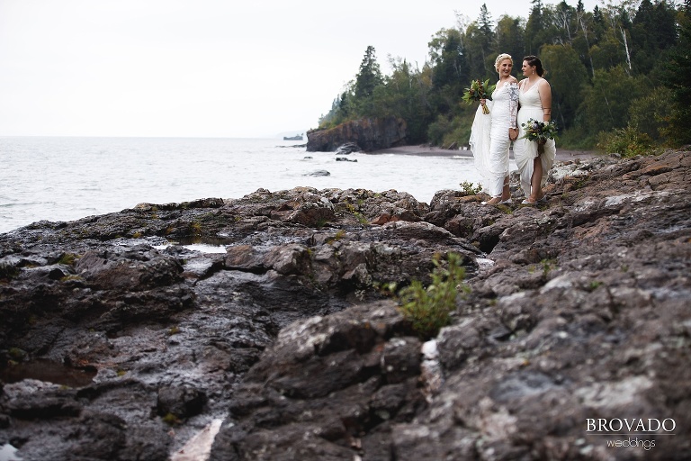 Two brides posing on the shore of lake superior