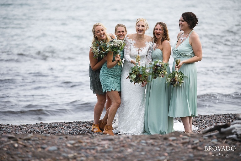 Nina posing with her bridesmaids in seafoam green dresses