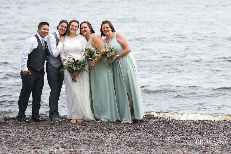 Karen posing with her wedding party on lake superior