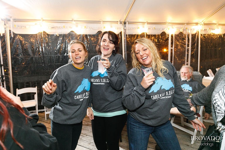 Wedding party dancing in matching sweatshirts