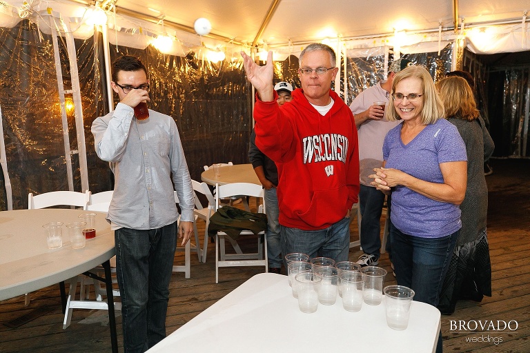 Parents playing beer pong at wedding reception