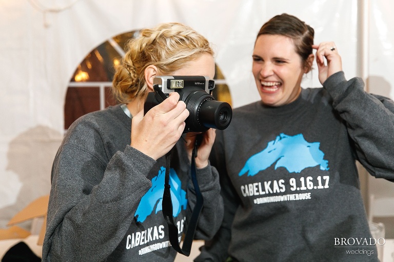 Nina and Karen taking instant polaroids at wedding reception