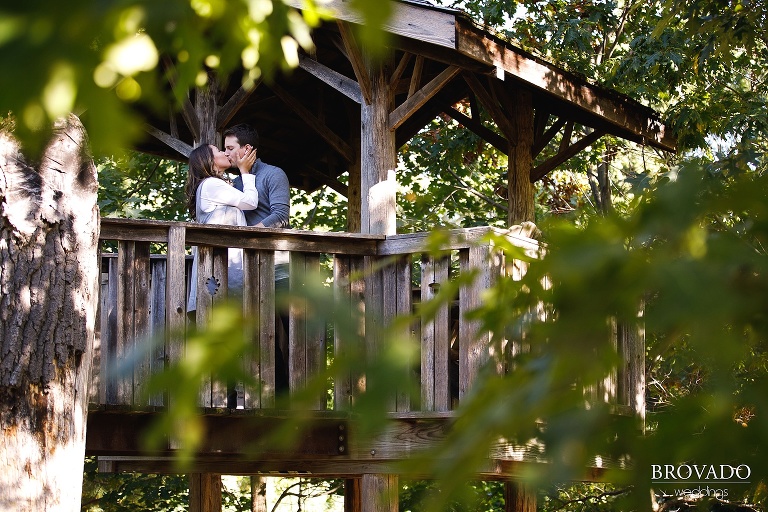 Engaged couple Hannah and Jason kissing in a treehouse