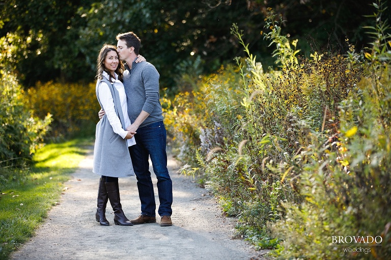Hannah looking at the camera while Jason kisses her forehead