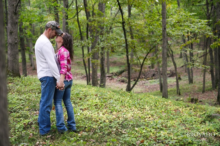 Kelly and Robert kissing in the woods