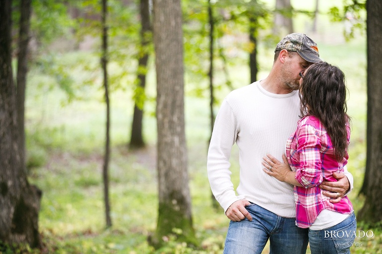 Robert and Kelly kissing in flannel and camo