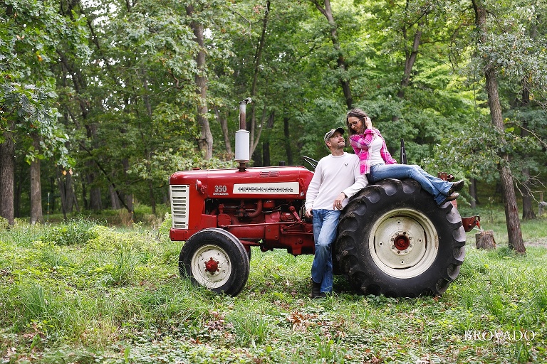 Kelly sitting on the wheel of her and Robert's tractor