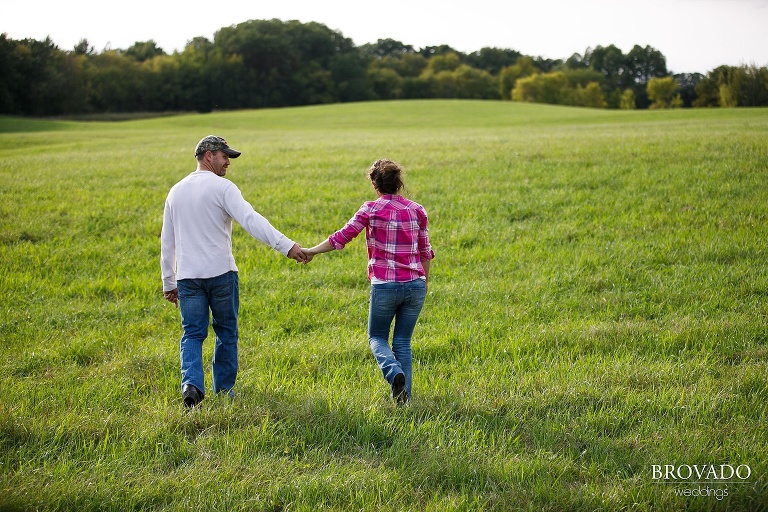 Fiances walking through a Minnesota field