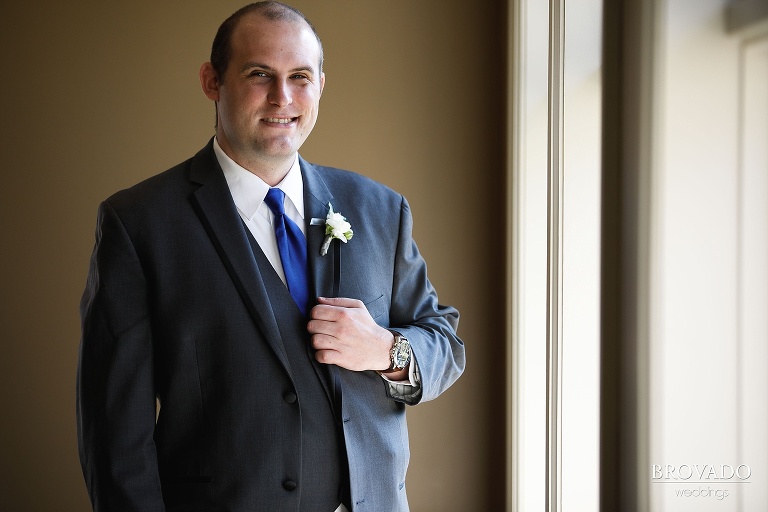 Formal portrait of Zach in grey suit with blue tie
