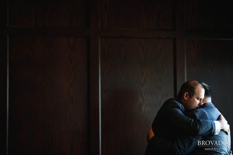 Grooms Tom and Zach embracing