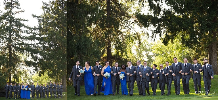 Outdoor wedding party in grey suits and bright blue dresses