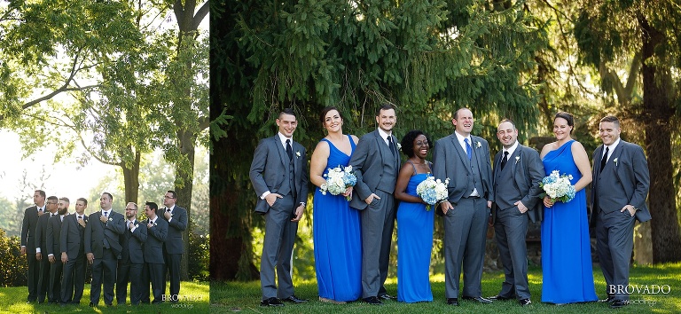 Zach and Tom posing with their respective wedding parties
