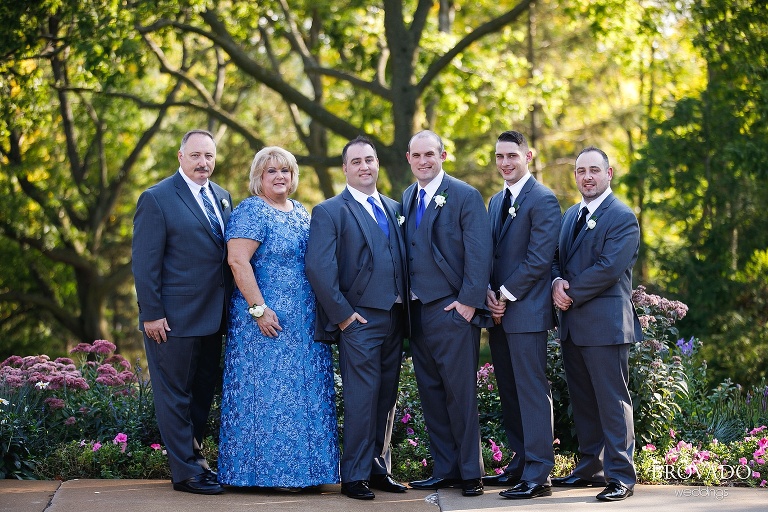 Grooms posing with their family