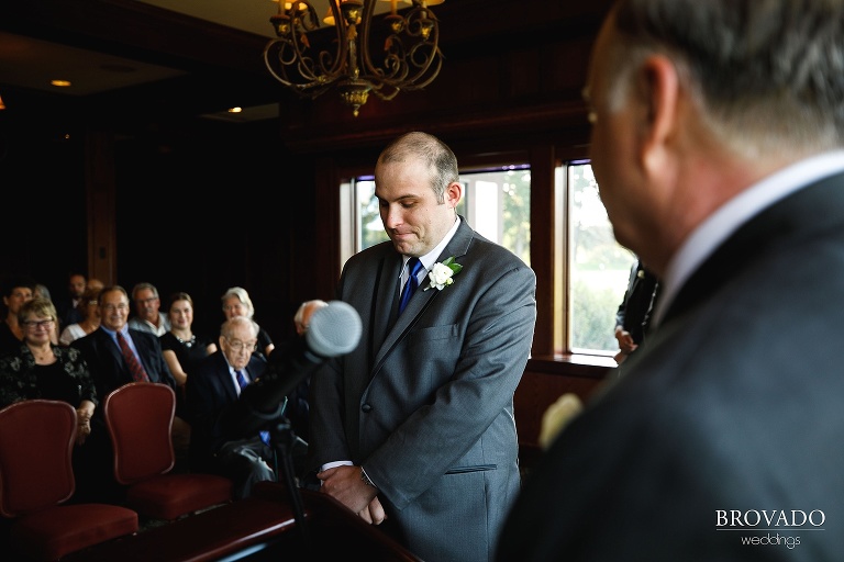 Zach standing at the front of the aisle waiting for his groom