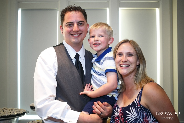 Groomsman and family posing at wedding reception