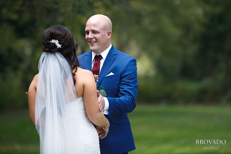 Derek smiling at the bride during first look