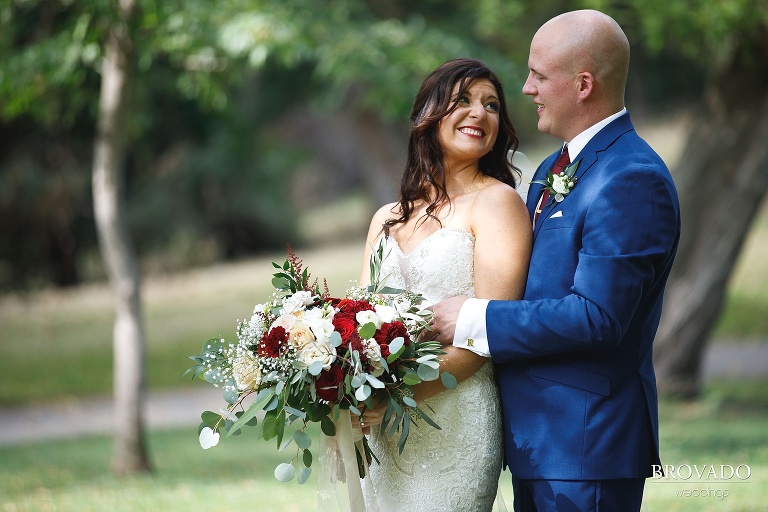 Brenna and Derek posing with Brenna's red bouquet