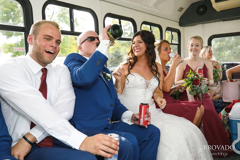 Brenna and Derek drinking champagne on their party bus