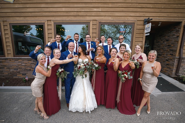 Brenna and Derek's wedding party holding their fireball shots