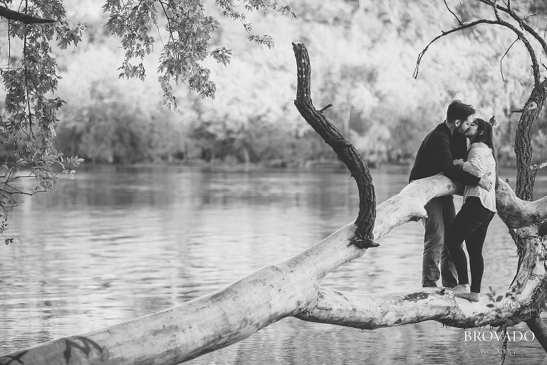 Yevgenia and Eugene kissing on a log