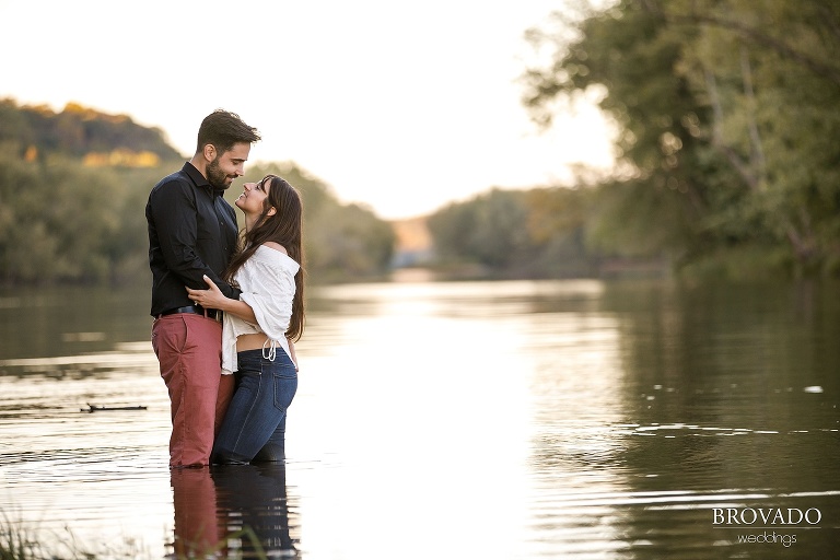 Engaged couple Geni and Eugene standing in st croix river