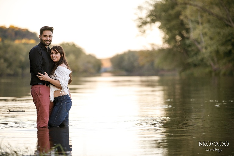 Yevgenia and Eugene smiling and standing in the st croix river