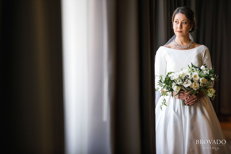 Hannah holding her off white bouquet