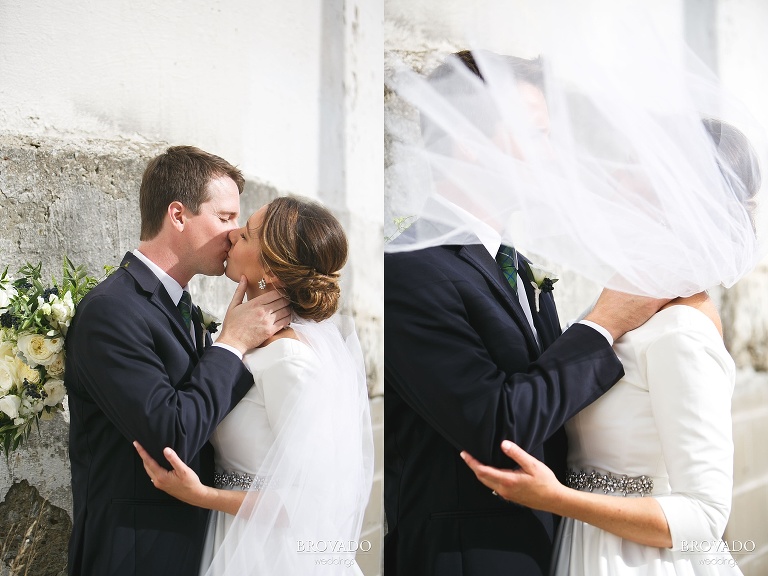 Jason and Hannah kissing against industrial backdrop