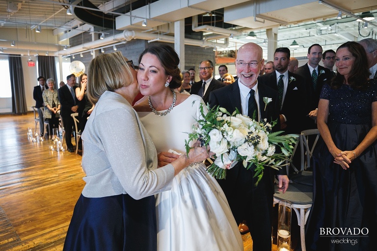 Hannah's mother kissing her on the cheek