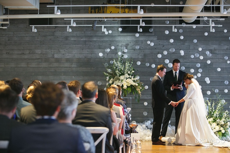 Bride Hannah wiping away a tear during wedding ceremony