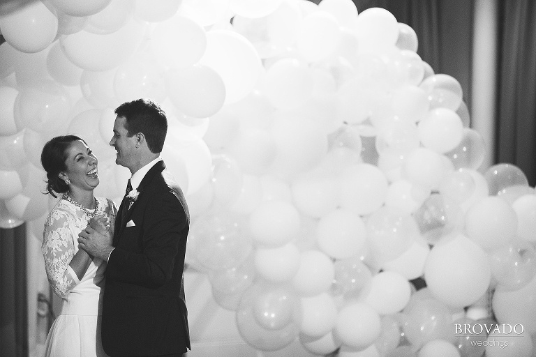 Hannah and Jason dancing in front of girl friday balloons
