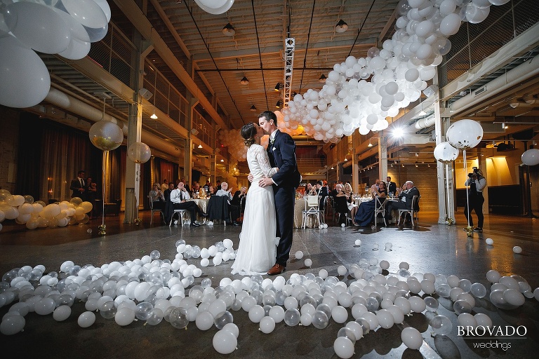 Hannah & Jason kissing surrounded by balloons