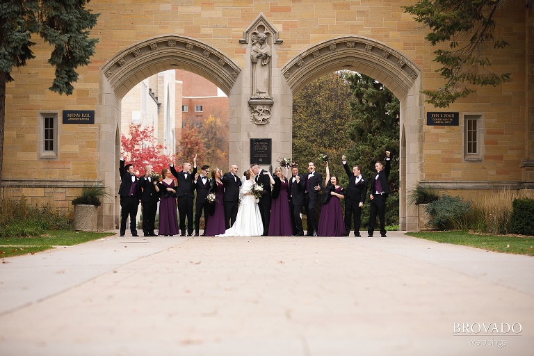 Megan and Ben's wedding party cheering outside of st thomas