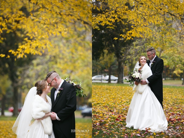 Newlyweds embracing on yellow fall leaves