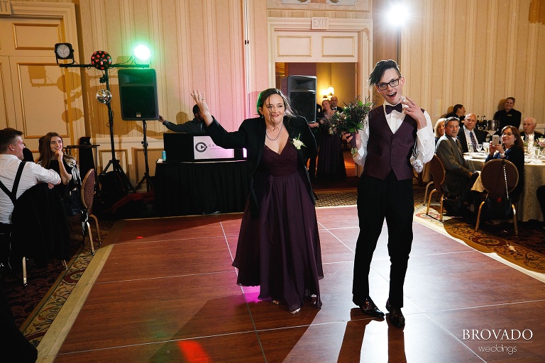 Wedding party dancing into reception during grand entrance