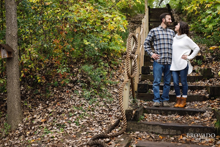 Stephanie and Loren posing on fall leaf covered stairs