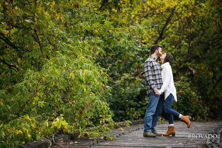 Stephanie and Loren kissing on railroad tracks