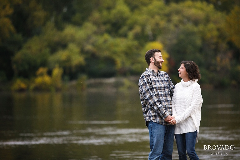 Stephanie and Loren laughing in front of fall leaves