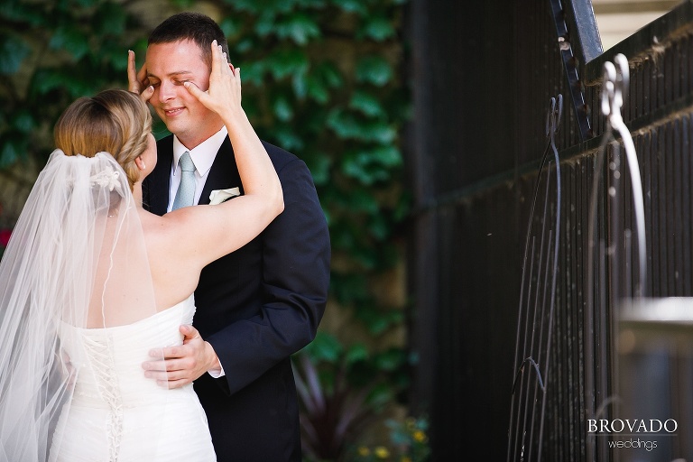 bride Annie wiping away groom Tyler's tears