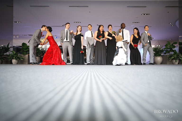 Wedding party laughing at flower girl