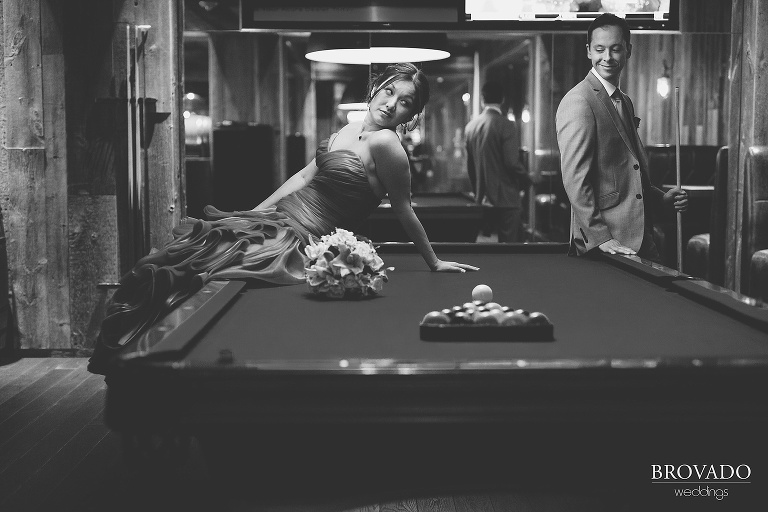 Bride Christine sitting on a pool table