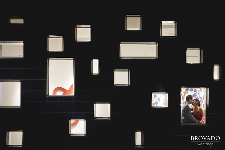 Artsy shot of Christine and Nick through radisson blu windows