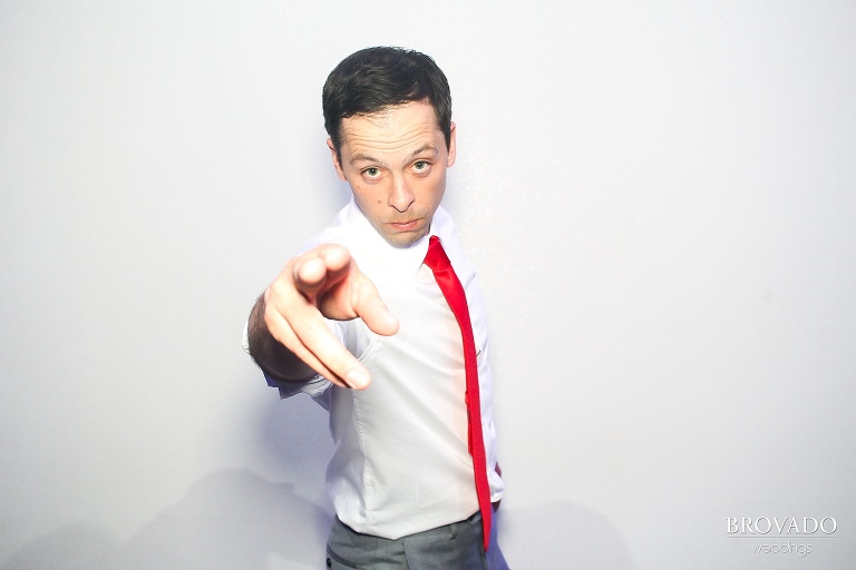 Nick in antibooth pointing at the camera