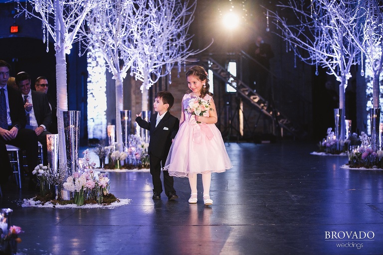 Flower girl and ring bearer walking down aisle